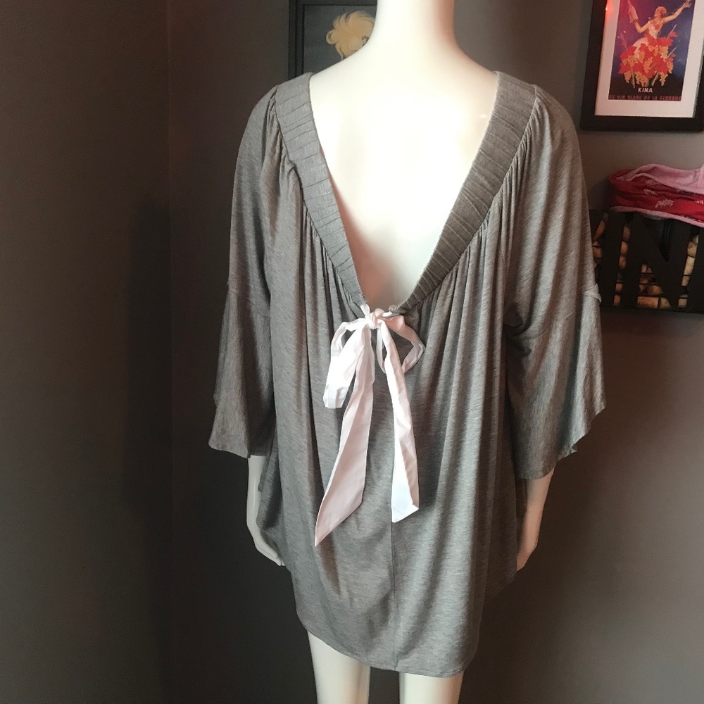 Grey, off the shoulder top with a bow in the back. Very cute!  Lightweight.